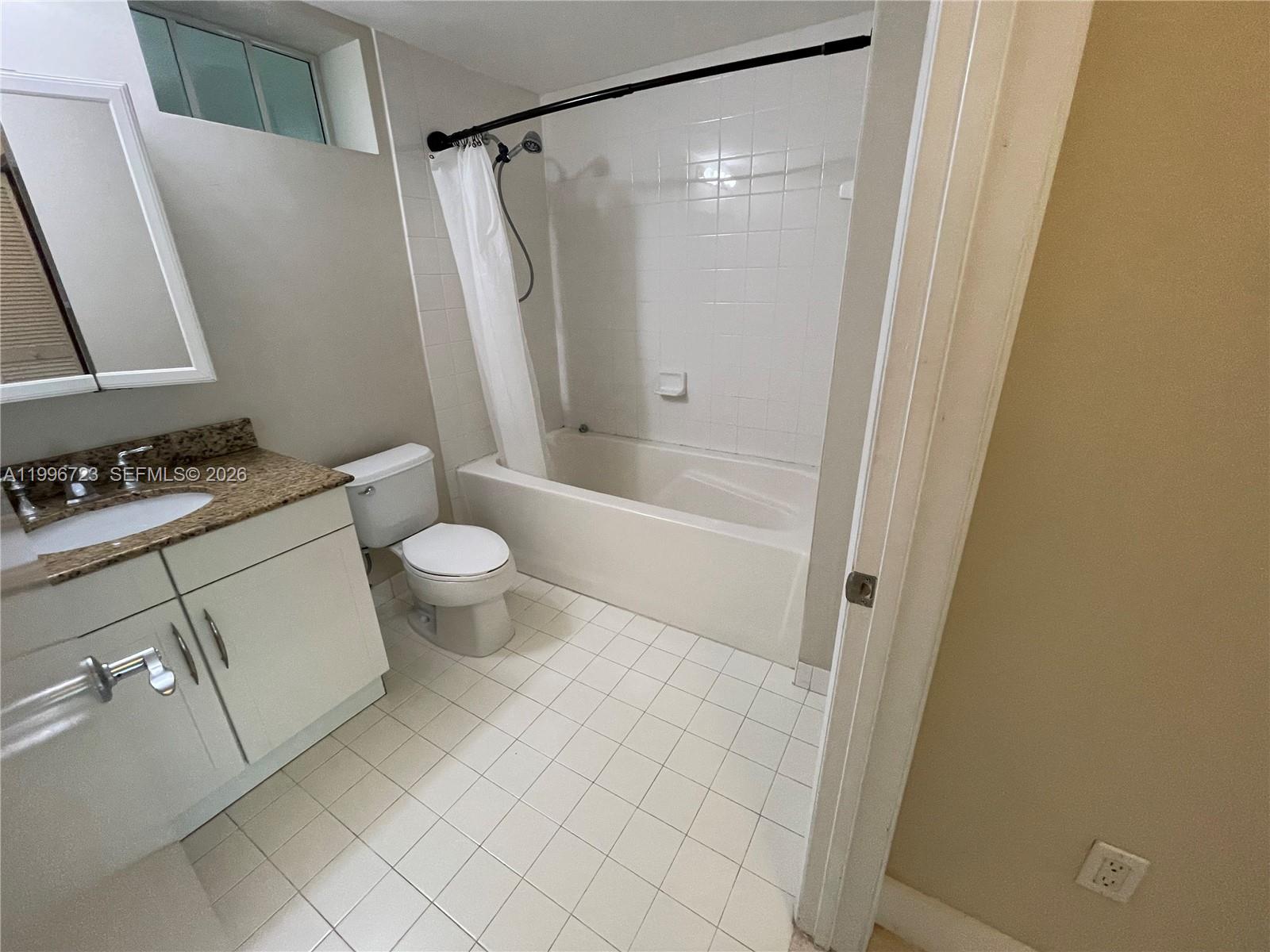 7290 Southwest 90th Street, Unit 307 Miami, FL 33156 - Photo 7 of 14 a bathroom with a bathtub and a toilet