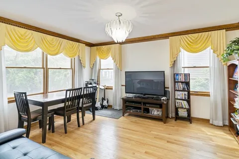 a view of a livingroom with furniture window and wooden floor