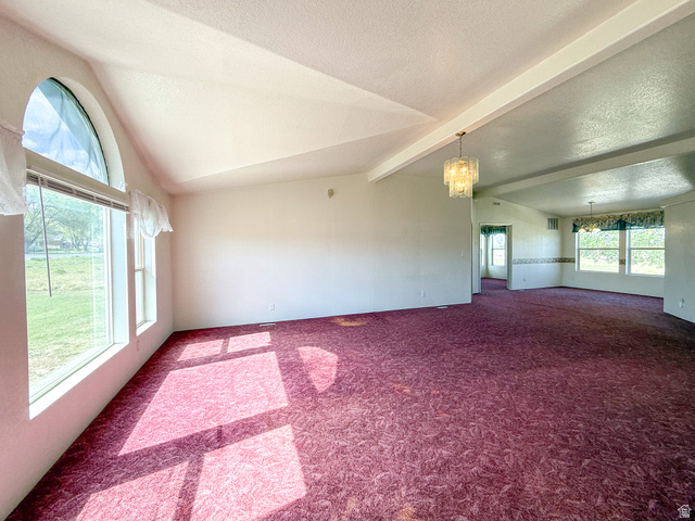 141 South 100 East Emery, UT 84522 - Photo 2 of 17 Spacious interior room featuring a vaulted ceiling and a large arched window