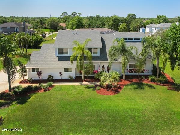 an aerial view of a house with swimming pool patio and outdoor seating