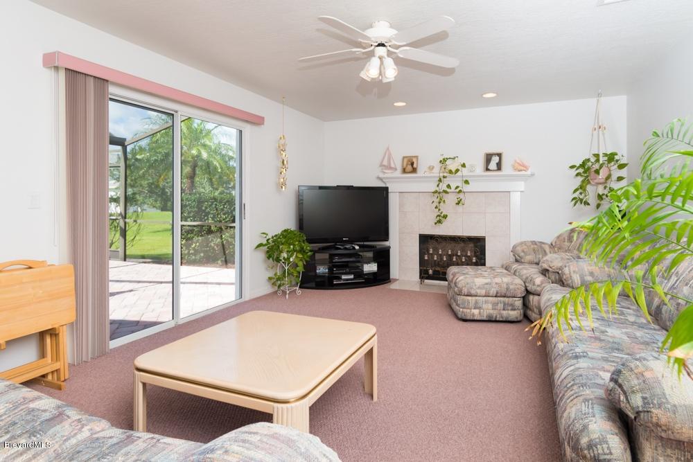 3570 Big Pine Road Melbourne, FL 32934 - Photo 12 of 27 a living room with furniture a flat screen tv and a large window