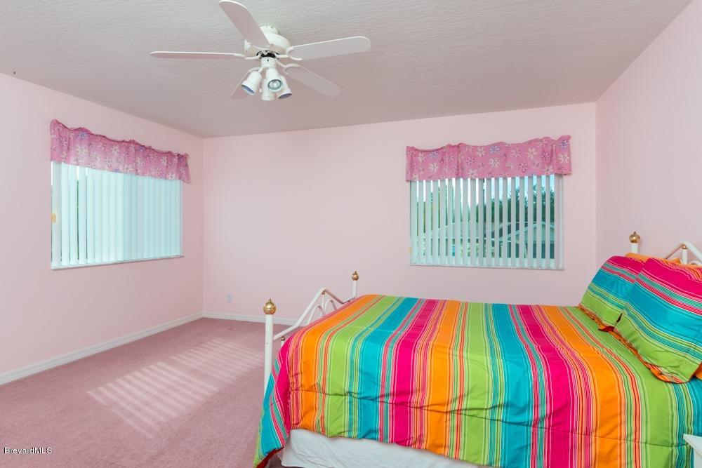 3570 Big Pine Road Melbourne, FL 32934 - Photo 17 of 27 a room that has a bed and a chair in it