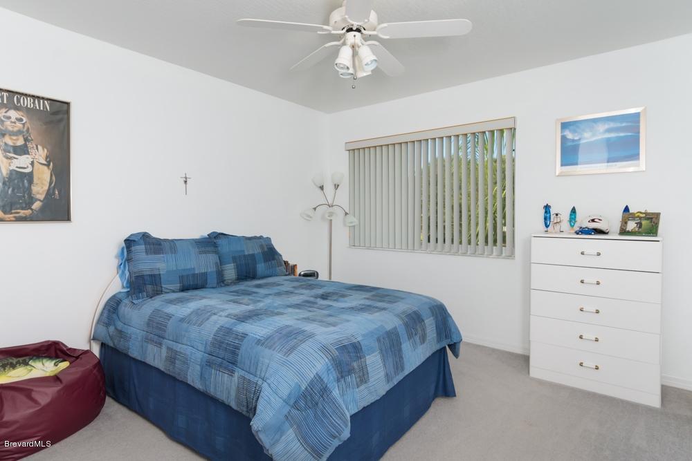 3570 Big Pine Road Melbourne, FL 32934 - Photo 18 of 27 a bedroom with a bed and a dresser