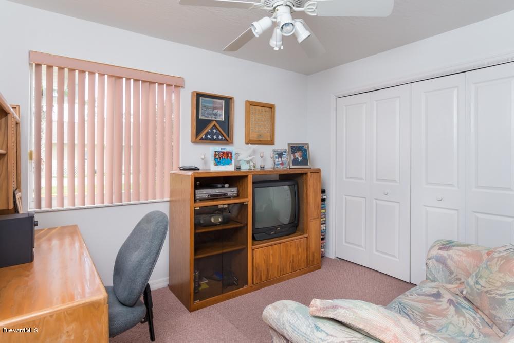 3570 Big Pine Road Melbourne, FL 32934 - Photo 19 of 27 a view of a livingroom with workspace and a window