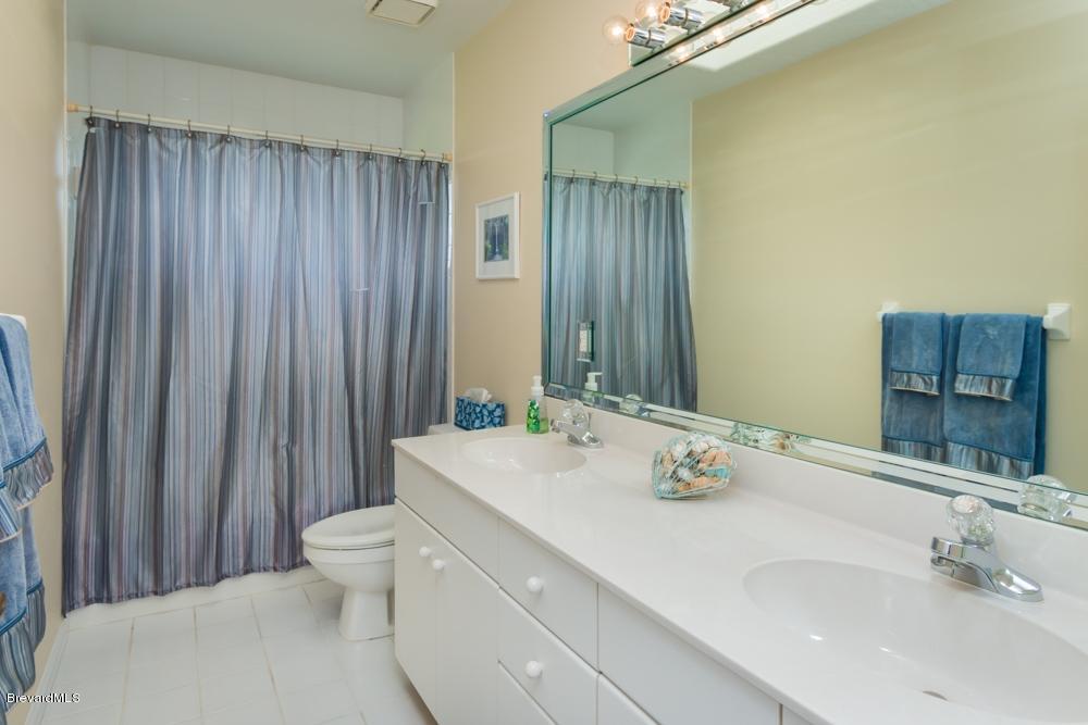 3570 Big Pine Road Melbourne, FL 32934 - Photo 21 of 27 a bathroom with a sink and a mirror