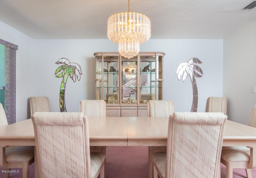 3570 Big Pine Road Melbourne, FL 32934 - Photo 7 of 27 a view of a dining room with furniture a chandelier and wooden floor