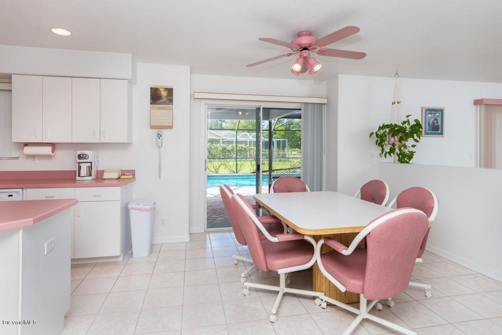 3570 Big Pine Road Melbourne, FL 32934 - Photo 10 of 27 a view of a dining room with furniture and a potted plant
