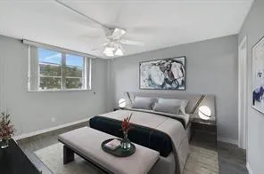 a bathroom with a granite countertop sink toilet a mirror and shower