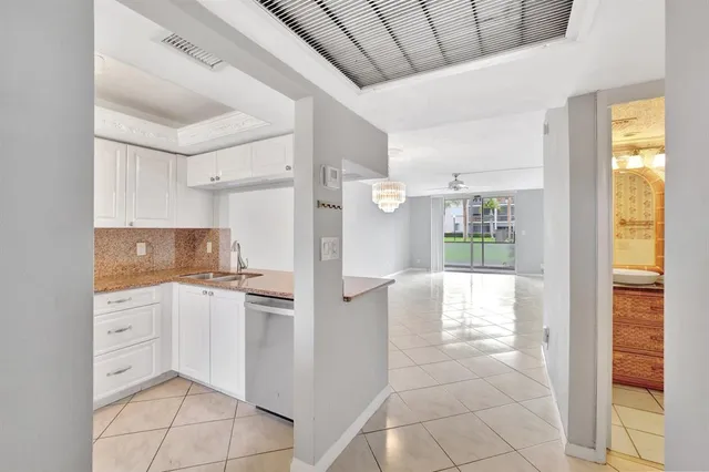a view of an empty room with a chandelier