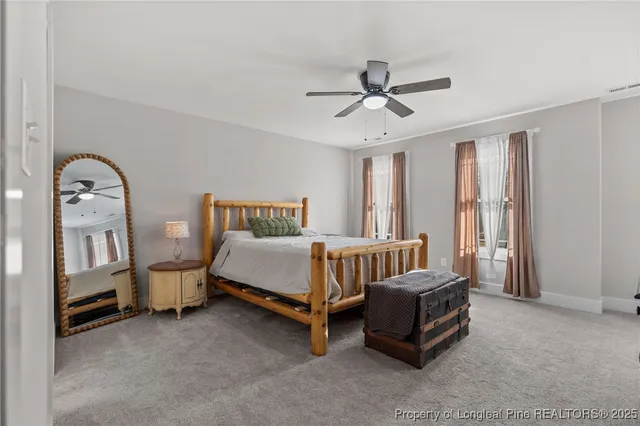 a spacious bedroom with a bed and a window