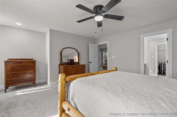 a bedroom with a bed and a ceiling fan