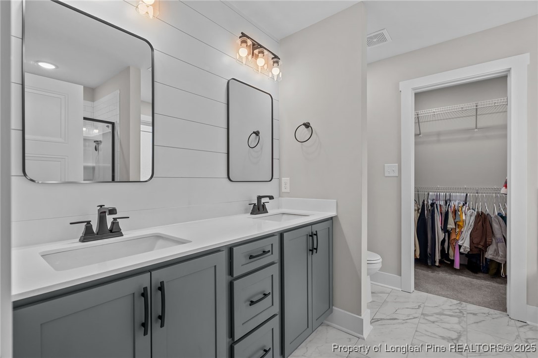 247 North Horace Walters Road Raeford, NC 28376 - Photo 20 of 35 a bathroom with a double vanity sink a and a mirror