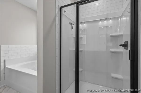a bathroom with a glass shower door