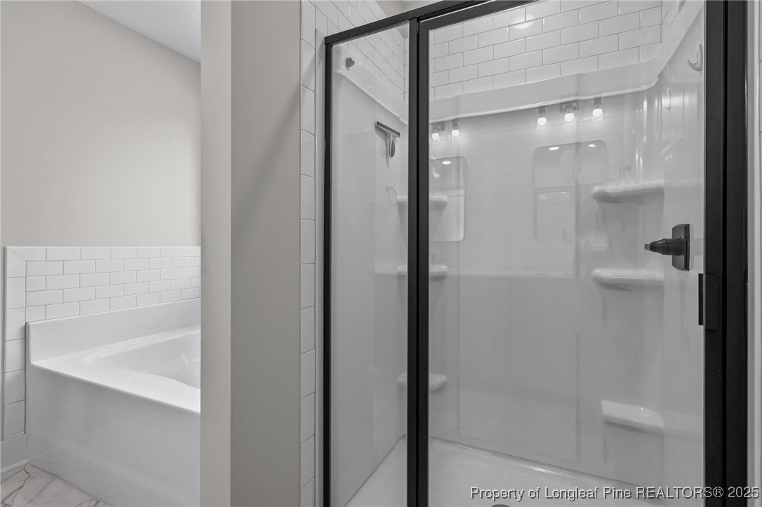 247 North Horace Walters Road Raeford, NC 28376 - Photo 21 of 35 a bathroom with a glass shower door