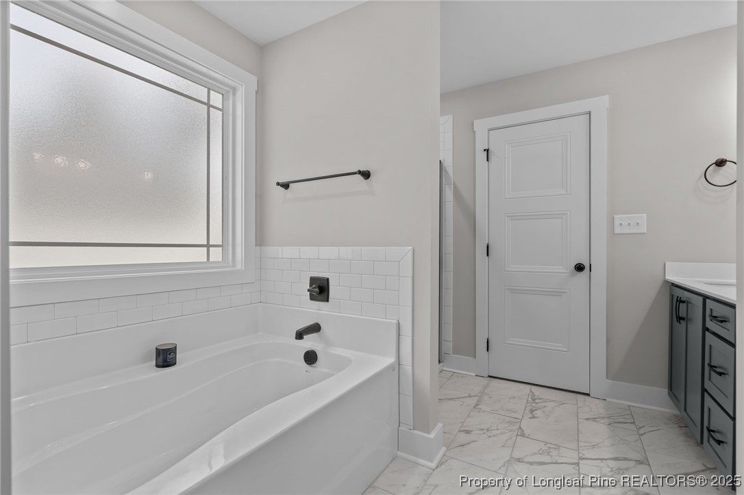 247 North Horace Walters Road Raeford, NC 28376 - Photo 22 of 35 a bathroom with a bathtub and a shower