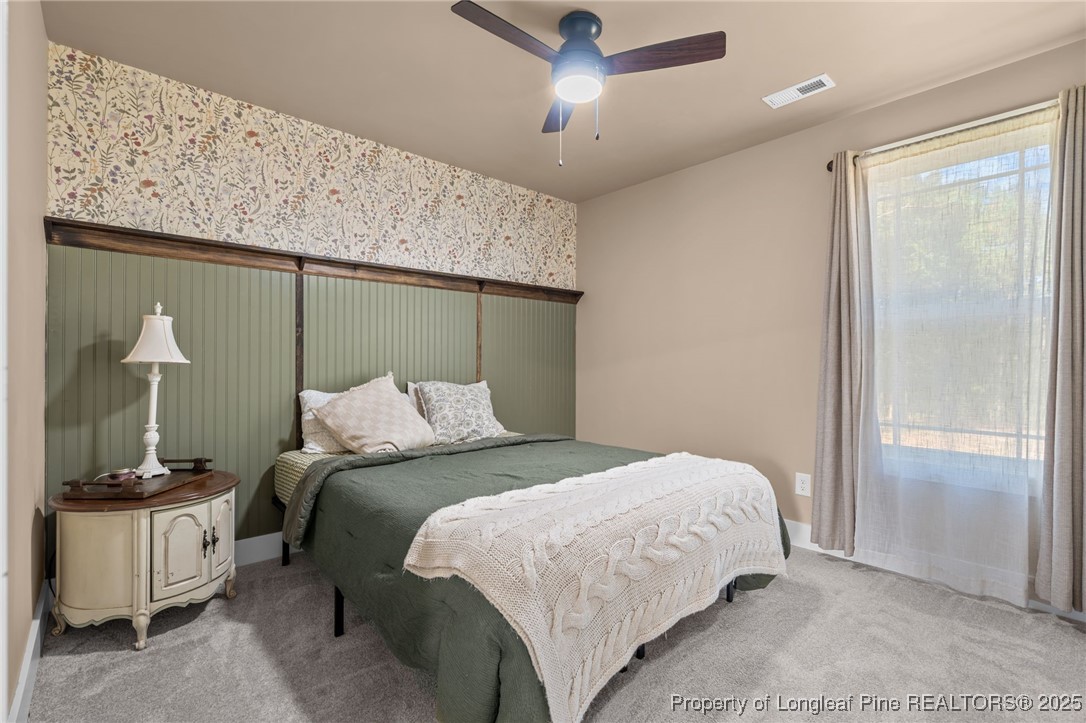247 North Horace Walters Road Raeford, NC 28376 - Photo 23 of 35 a bedroom with a bed and a mirror