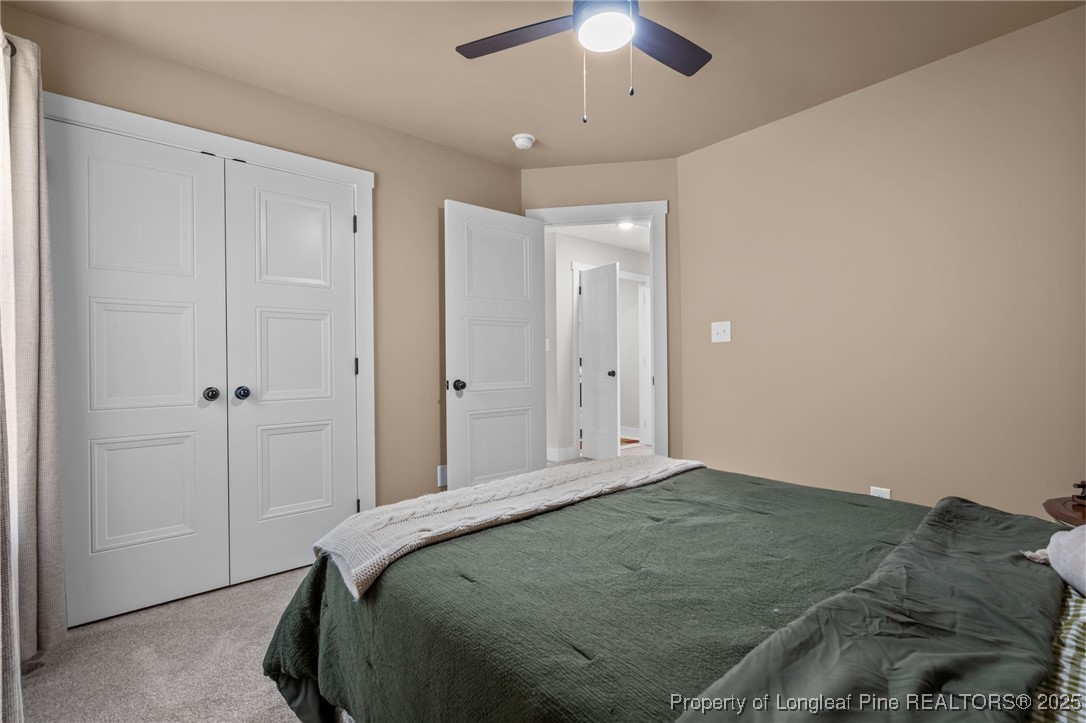 247 North Horace Walters Road Raeford, NC 28376 - Photo 24 of 35 a bedroom with a large bed and a chandelier fan