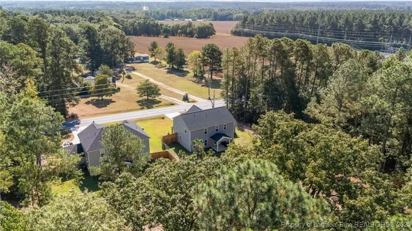 an aerial view of a house with a lake view