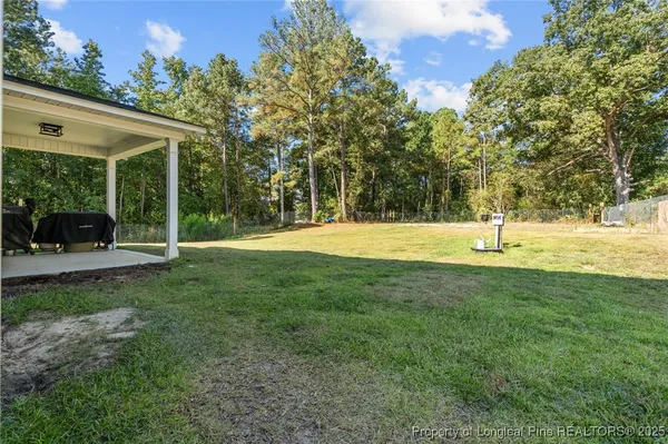 a view of outdoor space with deck and yard
