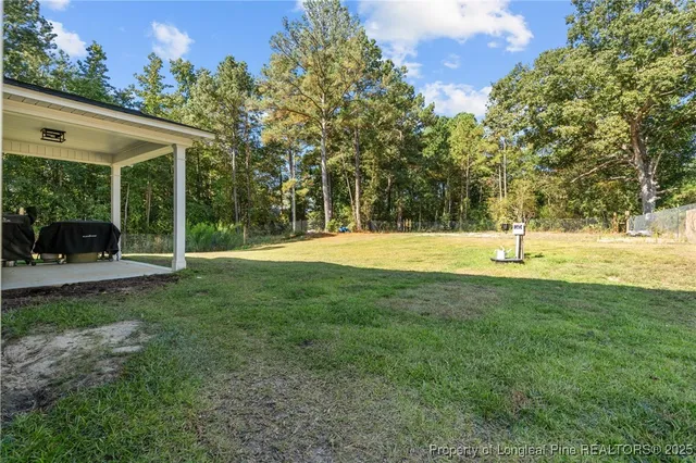 a view of outdoor space with deck and yard