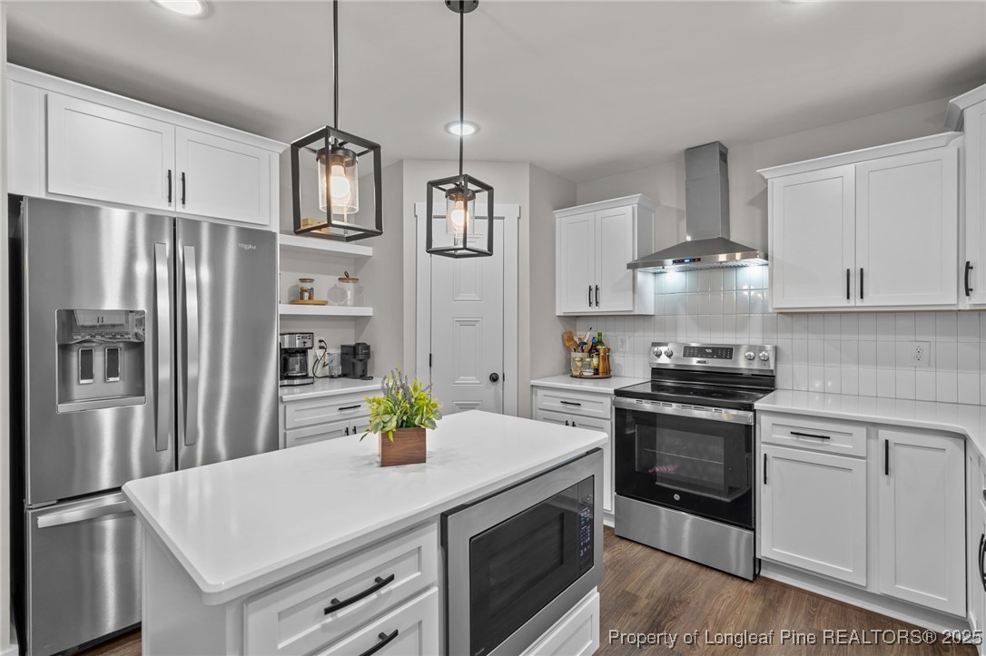 247 North Horace Walters Road Raeford, NC 28376 - Photo 4 of 35 a kitchen with stainless steel appliances granite countertop a sink a stove a refrigerator and a refrigerator with white cabinets