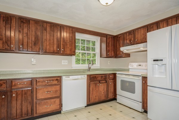 19 Robert Road Stow, MA 01775 - Photo 20 of 30 a kitchen with white cabinets and white appliances