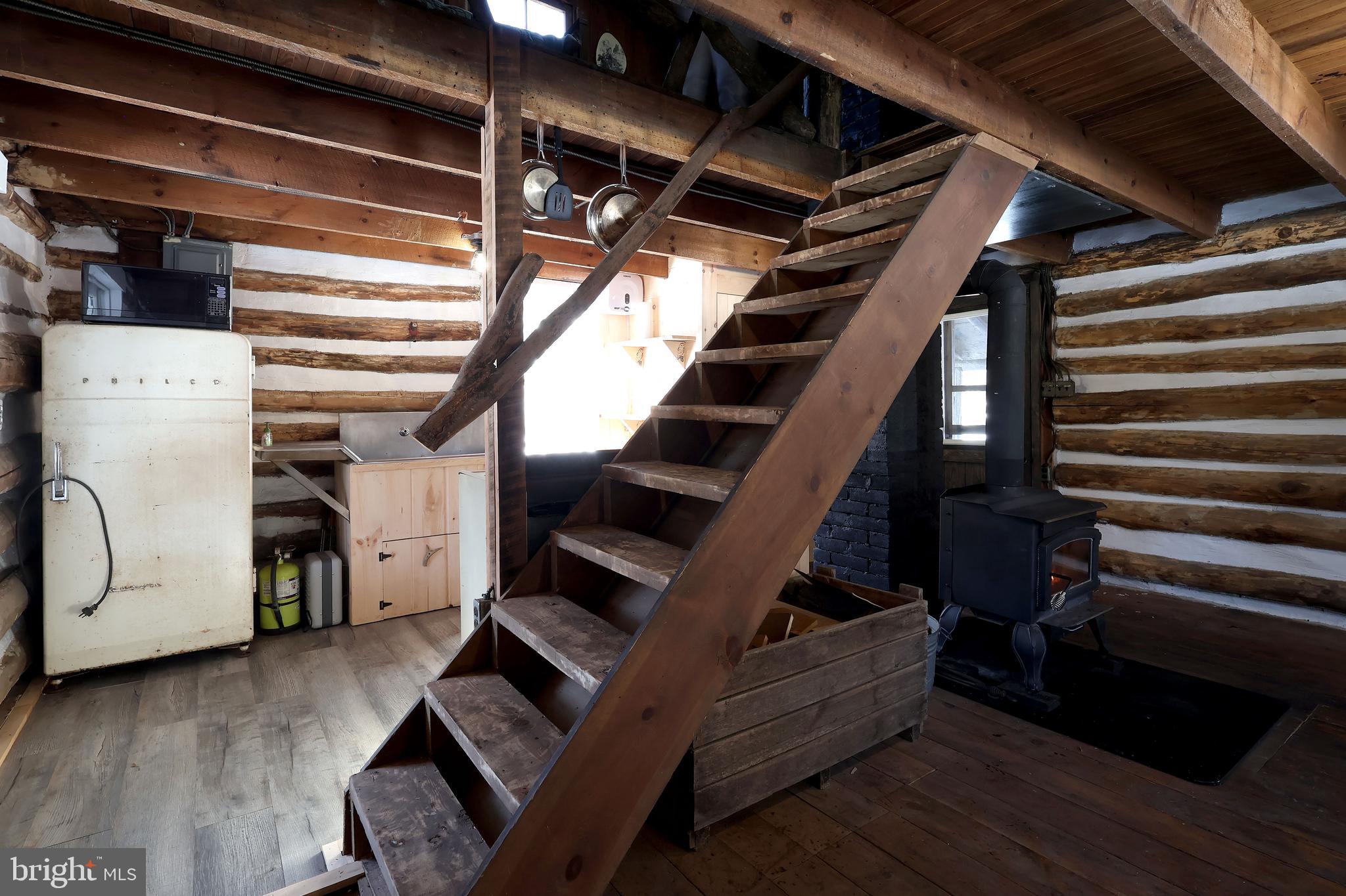4464 Tram Road Spruce Creek, PA 16683 - Photo 22 of 53 a view of staircase with lots of frames on wall and a window