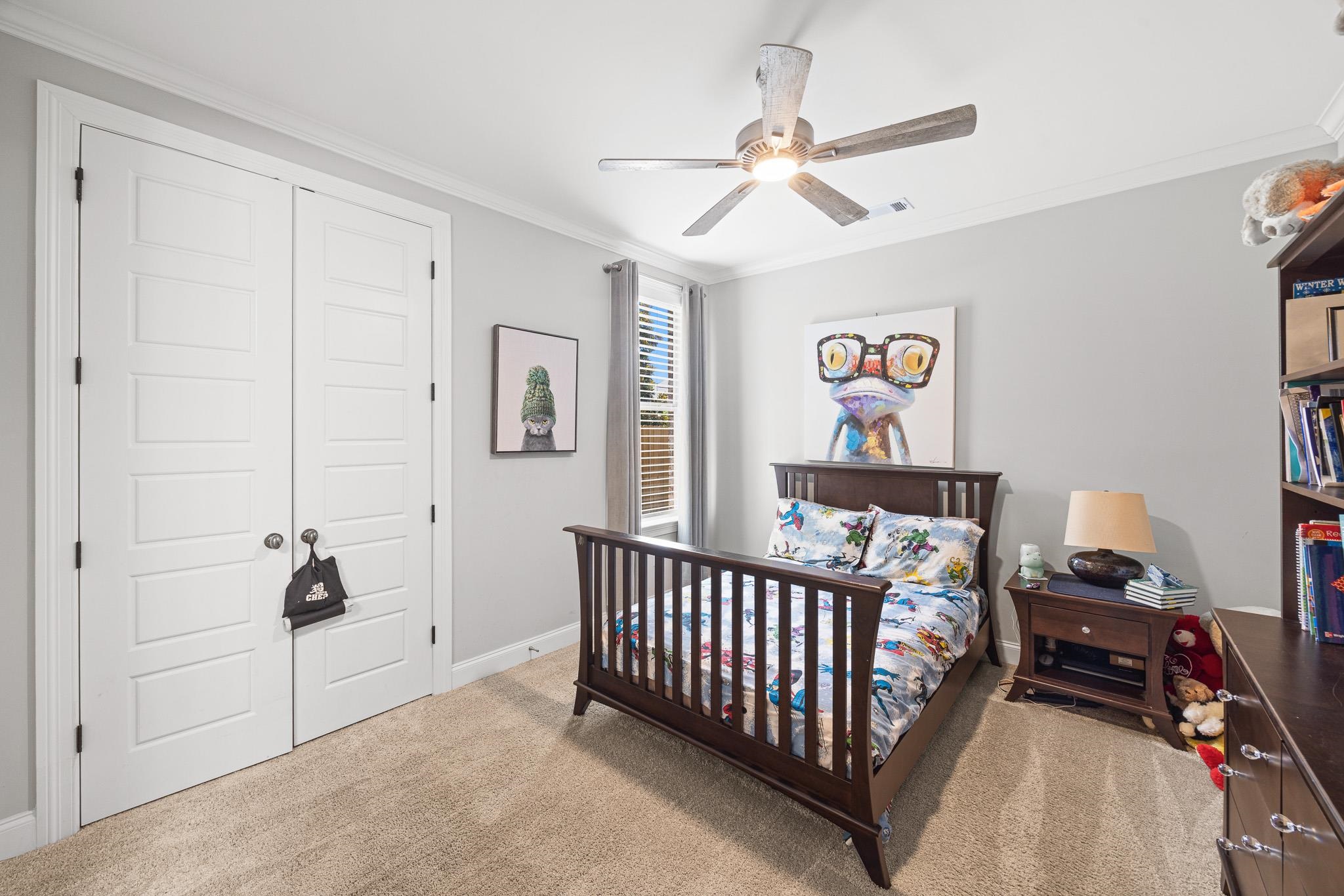 4711 Carousel Lane Collierville, TN 38017 - Photo 21 of 33 a bed room with a bed and a chandelier