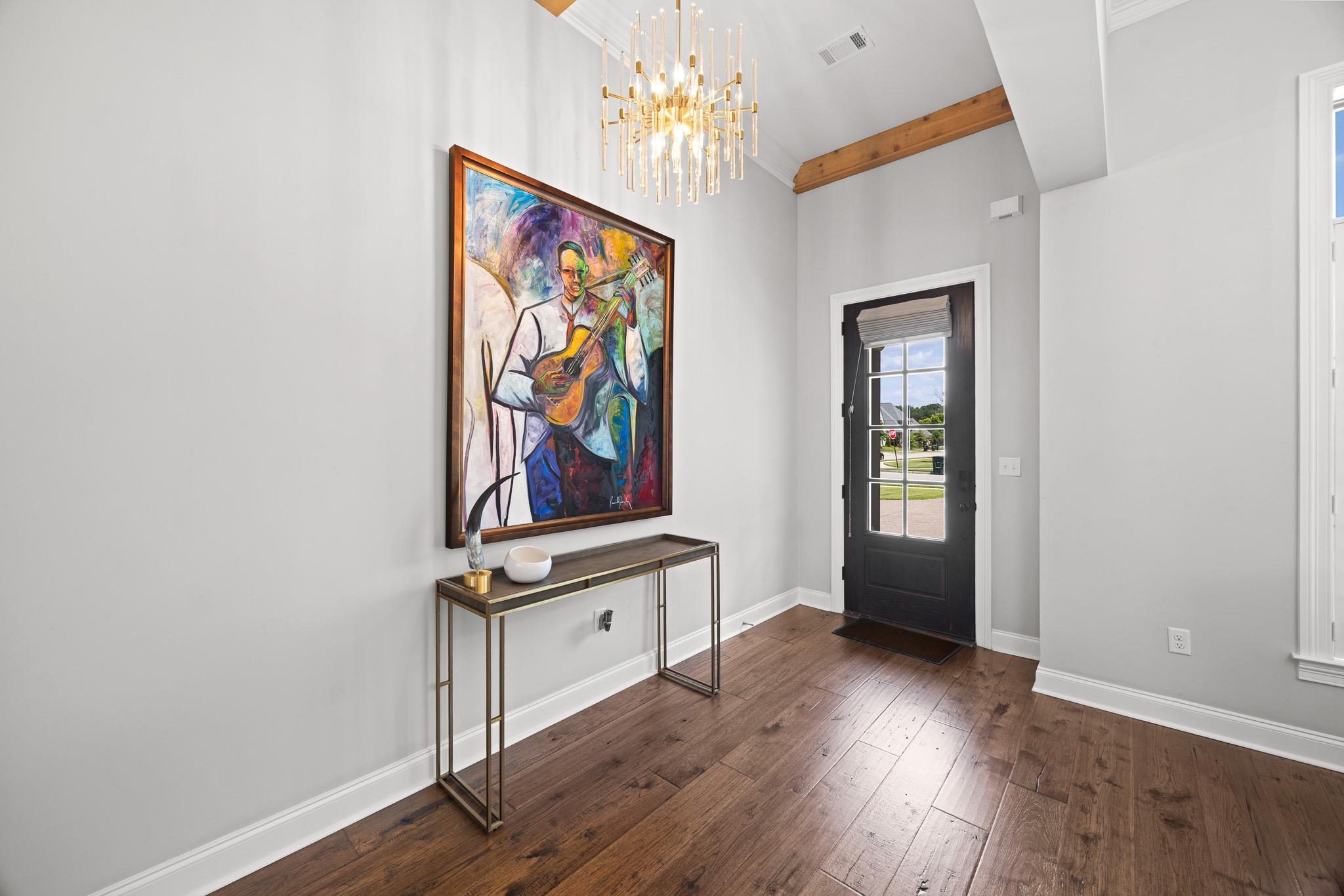 4711 Carousel Lane Collierville, TN 38017 - Photo 5 of 33 an empty room with wooden floor and painting on the wall