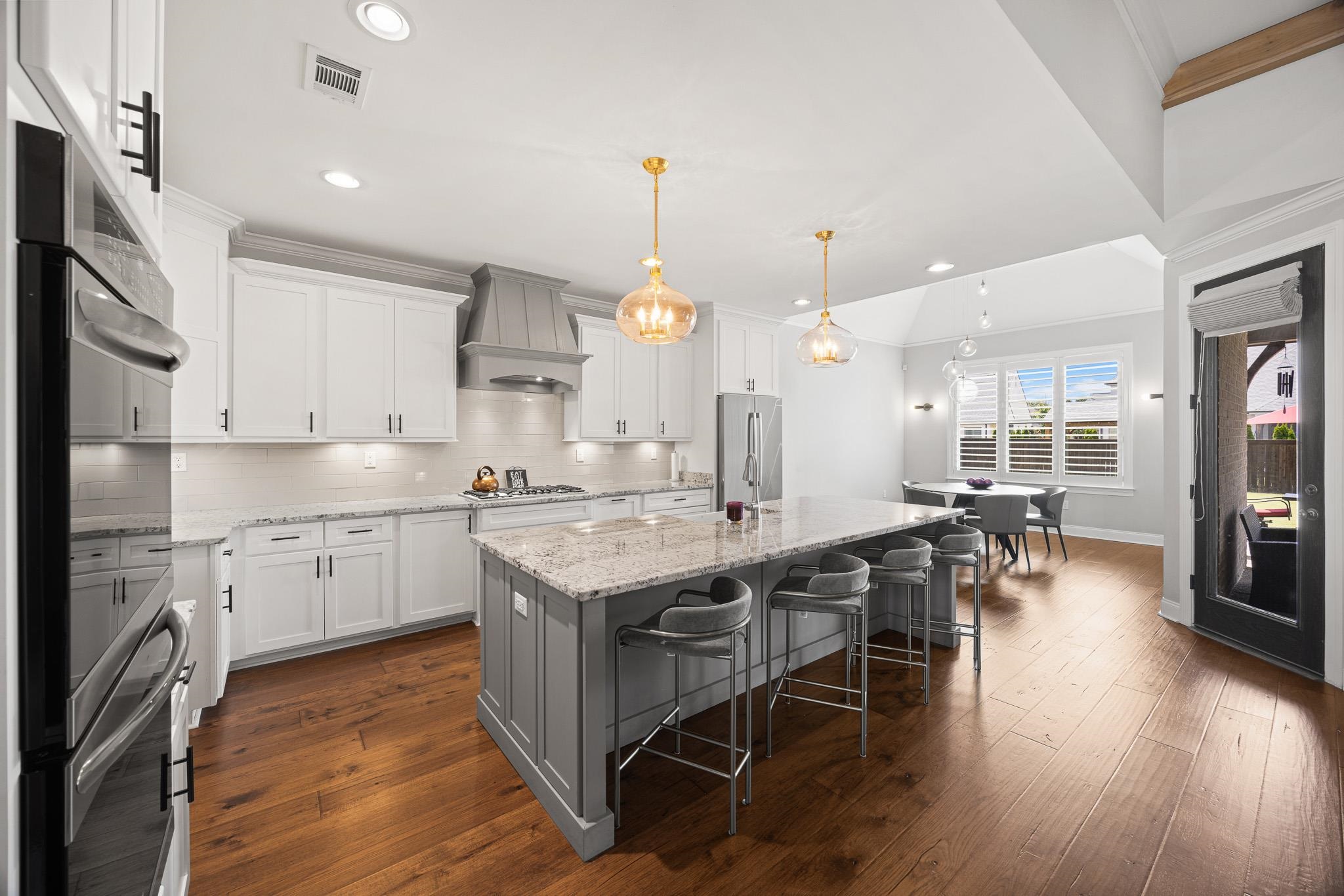 4711 Carousel Lane Collierville, TN 38017 - Photo 10 of 33 a kitchen with stainless steel appliances granite countertop a kitchen island a stove a table and chairs in it