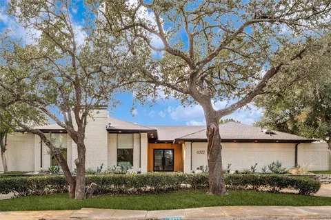 front view of a house with a tree