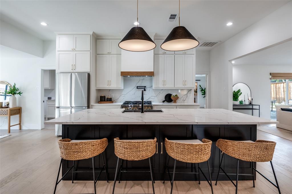 6322 Pineview Road Dallas, TX 75248 - Photo 12 of 40 a kitchen with stainless steel appliances a dining table and chairs