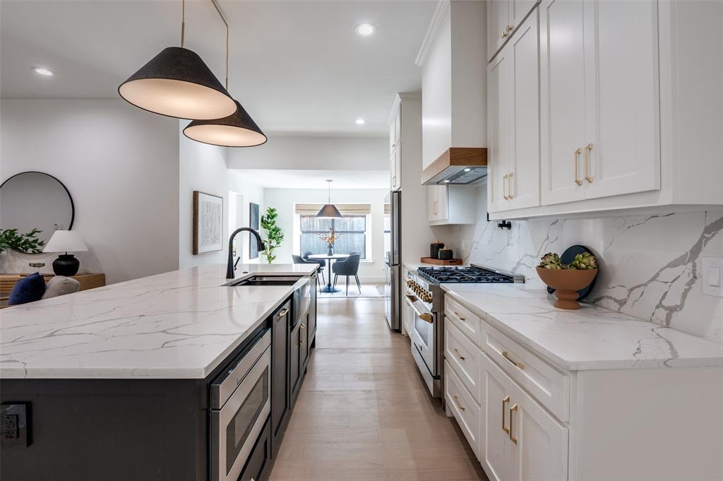 6322 Pineview Road Dallas, TX 75248 - Photo 14 of 40 a kitchen with granite countertop a sink a counter space and cabinets
