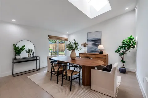 a view of a dining room with furniture and a potted plant