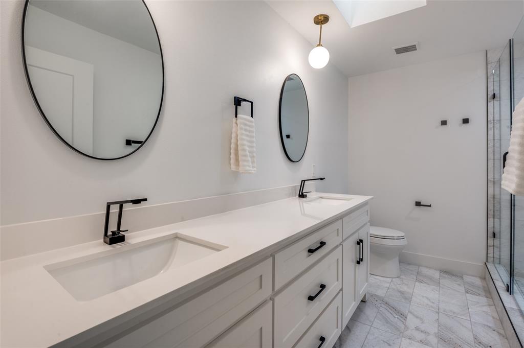 6322 Pineview Road Dallas, TX 75248 - Photo 26 of 40 a bathroom with a sink a toilet and a mirror
