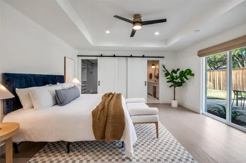 a bedroom with a large bed and a chandelier