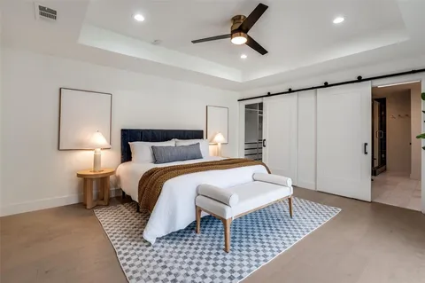 a bedroom with a bed and a lamp