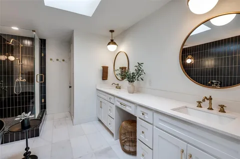 a spacious bathroom with a sink double vanity and a mirror