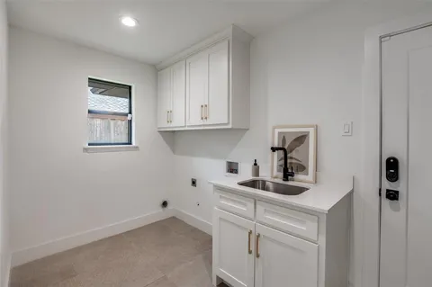 a kitchen with sink cabinets and a wooden floor