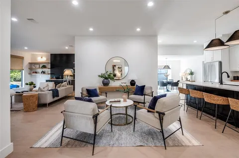 a living room with fireplace furniture and a wooden floor