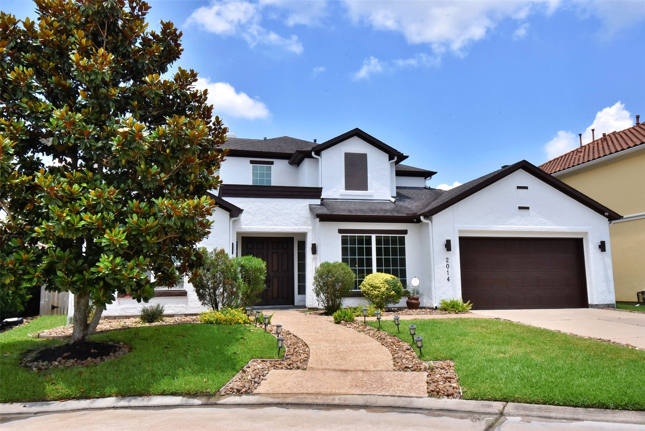 2014 Split Branch Court Houston, TX 77077 - Photo 2 of 47 a front view of a house with a yard and garage