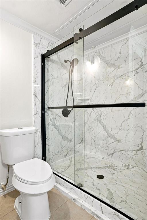 2601 Preston Road, Unit 4103 Plano, TX 75093 - Photo 12 of 16 Shower enclosure with clear glass and matte black hardware, featuring marble-finish wall and floor tiling