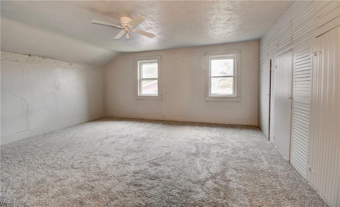 10337 Ragersville Road Southwest Baltic, OH 43804 - Photo 18 of 35 Additional living space featuring carpet, ceiling fan, a textured ceiling, and vaulted ceiling