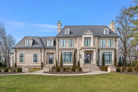 a bedroom with a bed and a flat tv screen on the dresser