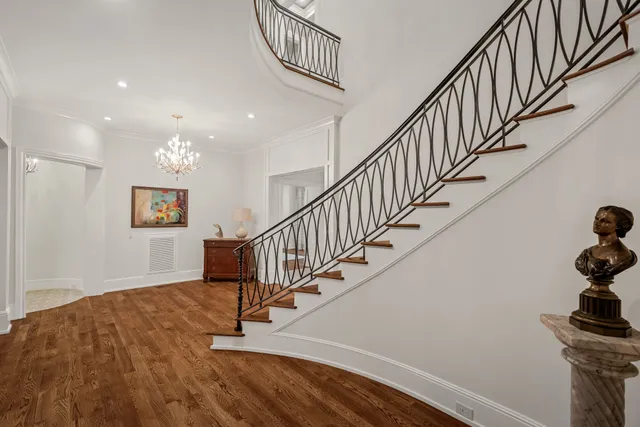 a view of a livingroom with wooden floor and stairs