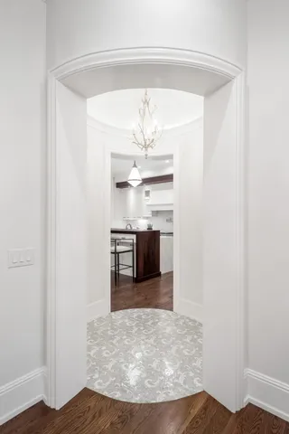 a living room with furniture chandelier and a large window
