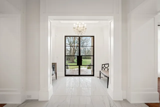 an empty room with windows and ceiling fan