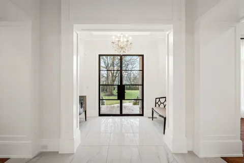 an empty room with windows and ceiling fan