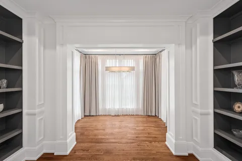 a view of a room with wooden floor and closet