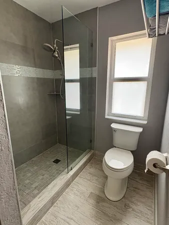 a bathroom with a toilet and a shower